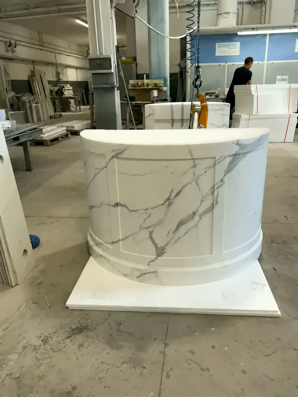 Bancone reception curvo in marmo bianco venato con specchiature sul fronte, officina Savoia Marmi
